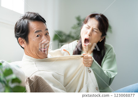 A wife in her 50s questions her husband A wife in her 50s questions her husband 123008877