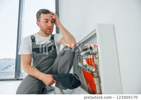 Conception of failure. Repairman is working indoors in the modern room 123009170