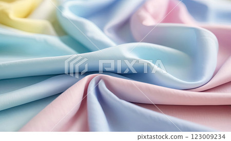 Flowing pastel colors pink, blue, yellow blend beautifully across the fabric waves, featuring gentle hues Flowing pastel colors pink, blue, yellow blend beautifully across the fabric waves, featuring gentle hues 123009234