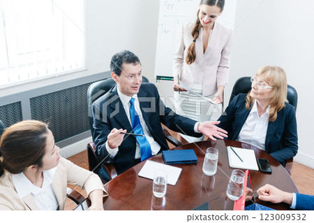 manager sharing his opinion while interpreting a pie-chart during board meeting 123009532