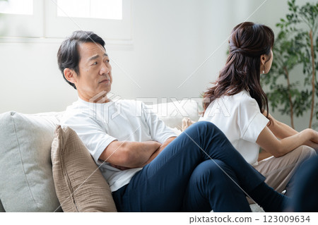 A husband in his 50s apologizing to his angry wife A husband in his 50s apologizing to his angry wife 123009634