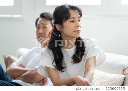 A husband in his 50s apologizing to his angry wife A husband in his 50s apologizing to his angry wife 123009635