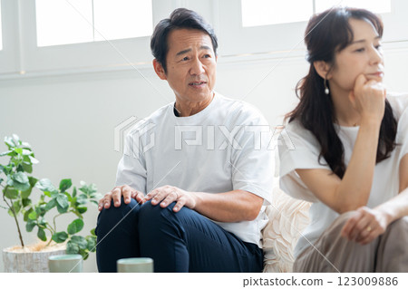 A husband in his 50s apologizing to his angry wife 123009886