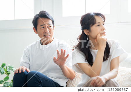 A husband in his 50s apologizing to his angry wife A husband in his 50s apologizing to his angry wife 123009887