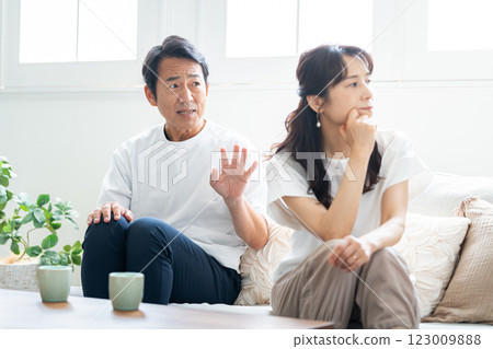 A husband in his 50s apologizing to his angry wife A husband in his 50s apologizing to his angry wife 123009888