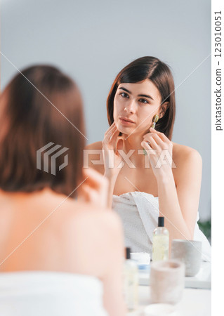 Clean skin. Young woman is at home. Conception of beauty 123010051