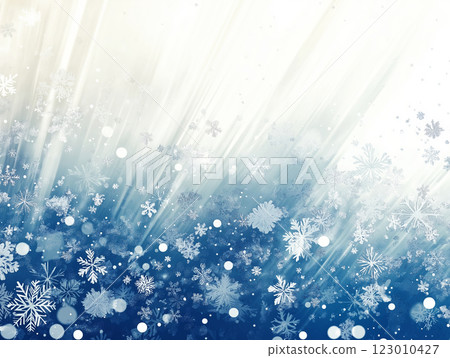 An abstract winter background with delicate falling snowflakes and a cool gradient of blue and white tones 123010427