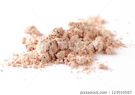 A sample of dry cosmetic clay for a mask or cosmetic powder. White background A sample of dry cosmetic clay for a mask or cosmetic powder. White background 123010567