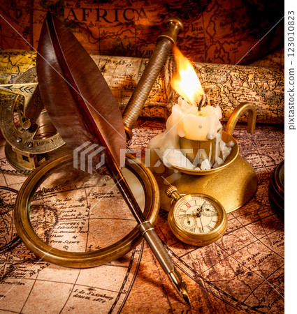 Vintage style travel and adventure. Vintage old compass and other vintage items on the table. 123010823