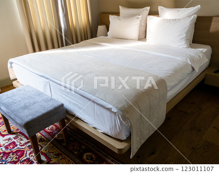 double bed with white linens in hotel room 123011107