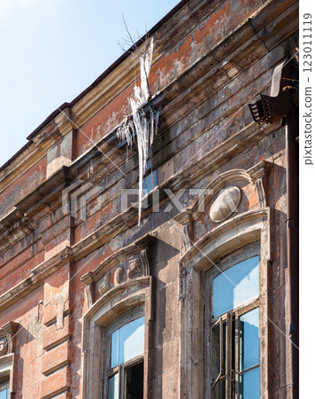 icicle hanging from roof of shabby house in Gyumri 123011119