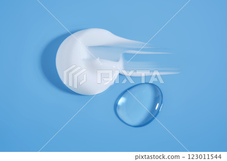 A smear of white cream And a drop of serum on a blue background. A smear of white cream And a drop of serum on a blue background. 123011544