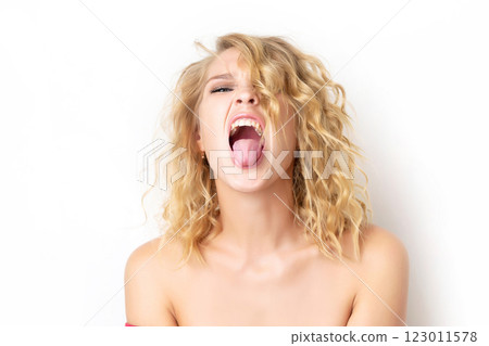 |Portrait of a woman with foolish grimace showing tongue and teasing isolated at white background. Concept of joy crazy lifestyle. Funny emotion. 123011578
