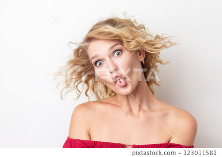 Closeup portrait of a woman with foolish grimace isolated at white background. Concepy of joy and careless lifestyle. Funny emotion. Closeup portrait of a woman with foolish grimace isolated at white background. Concepy of joy and careless lifestyle. Funny emotion. 123011581