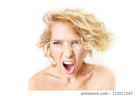 Closeup portrait of angry shouting woman with focus on hair and blurred face isolated at white background. Closeup portrait of angry shouting woman with focus on hair and blurred face isolated at white background. 123011587