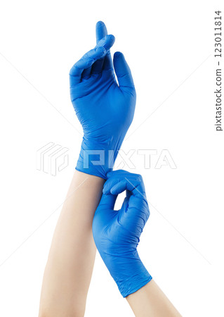 Vertical image of female hands with blue medical gloves isolated at white background. Virus pandemic prevertion. Hands protection and healthcare. 123011814