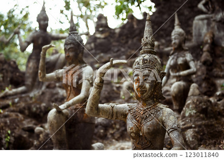 Row of old statues in secret buddhist garden. Concept of mysterious place for relaxation and meditation. 123011840