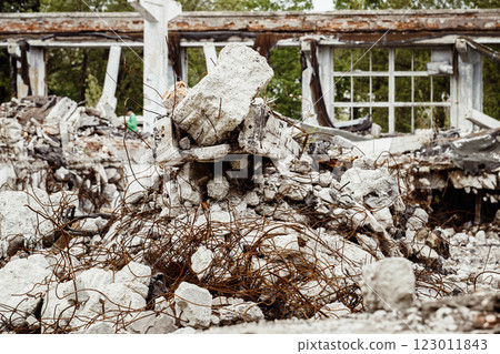 A closeup image of a ruined building with concrete and armature around. Concept of disaster, war. A closeup image of a ruined building with concrete and armature around. Concept of disaster, war. 123011843