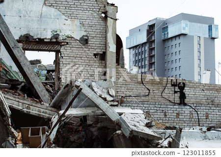 Dirty abandoned trash ruins with modern office building at background. Concept of old and new contrast, rich and poor. 123011855
