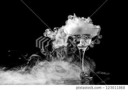 Closeup wine glass with fog at dark background. Chemical reaction of dry ice with water. Closeup wine glass with fog at dark background. Chemical reaction of dry ice with water. 123011868