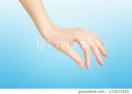 Closeup female hand making picking gesture isolated at blue background. 123011930