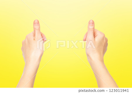 Closeup empty female hands making holding gesture isolated at yellow background. Closeup empty female hands making holding gesture isolated at yellow background. 123011941