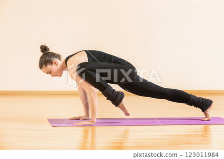 Young woman is training fitness on a mat at home. 123011984