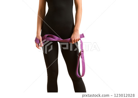 Slim athlete woman is holding trx straps for fitness training at isolated white background. Slim athlete woman is holding trx straps for fitness training at isolated white background. 123012028