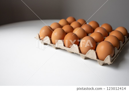 Chicken eggs in a paper tray side view with white background 123012414