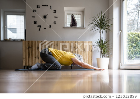 Peaceful yoga practice of a senior man 123012859