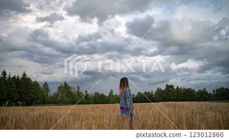 Woman gazing into the storm clouds 123012860