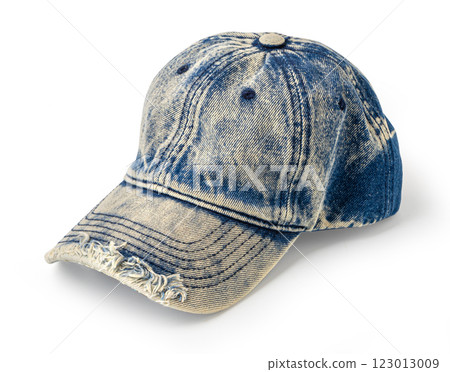 Light blue denim baseball cap with frayed brim on white background Light blue denim baseball cap with frayed brim on white background 123013009