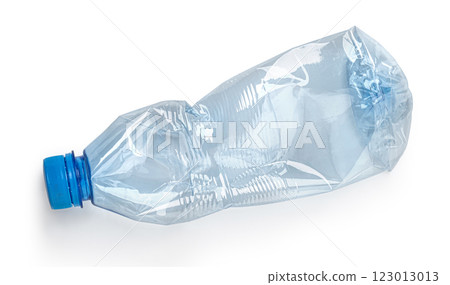 Crushed plastic bottle lying on white background representing recycling 123013013