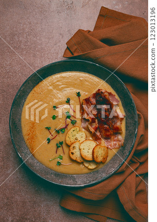 Pumpkin cream soup, curry, fried bacon, bruschetta chips,micro-greens, top view, no people, Pumpkin cream soup, curry, fried bacon, bruschetta chips,micro-greens, top view, no people, 123013196
