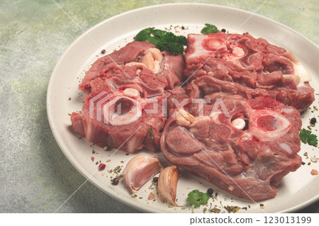 raw steak, calf's neck on the bone, fresh meat, on a white plate, top view, no people, 123013199
