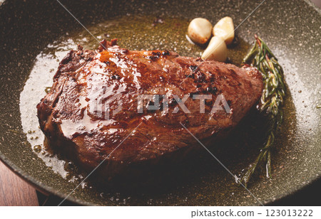 fried steak, beef steak, rib eye steak, in a frying pan, top view, no people fried steak, beef steak, rib eye steak, in a frying pan, top view, no people 123013222