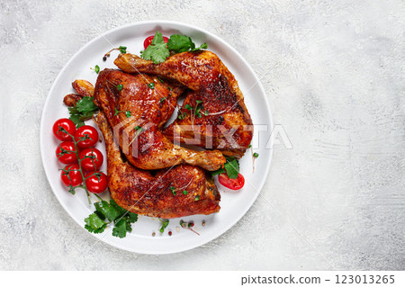 grilled fried chicken legs, served, with fresh cherry tomatoes, and herbs, on a white plate, homemade, no people, 123013265