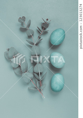 composition of eucalyptus leaves and turquoise colored eggs, on a gray background, Easter card, top view, no people, 123013274