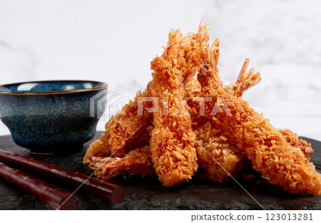 shrimp in tempura, deep fried, on black slate, with sauce, light marble table, no people, 123013281