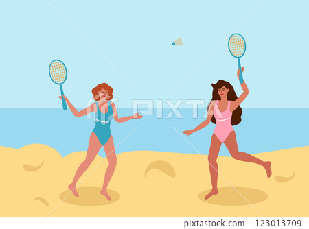 Two young women playing badminton on the beach 123013709