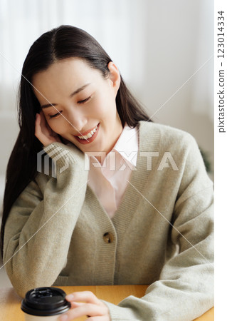 Businesswoman sitting at a table and thinking Businesswoman sitting at a table and thinking 123014334
