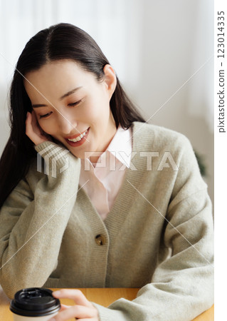Businesswoman sitting at a table and thinking Businesswoman sitting at a table and thinking 123014335