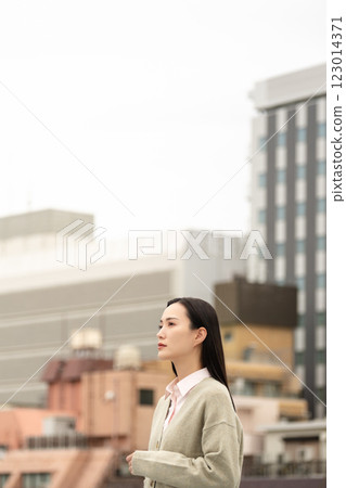 Business woman standing in the city Business woman standing in the city 123014371