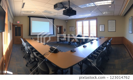 Modern conference room with u-shaped table, projector, screen, and windows. 123014762
