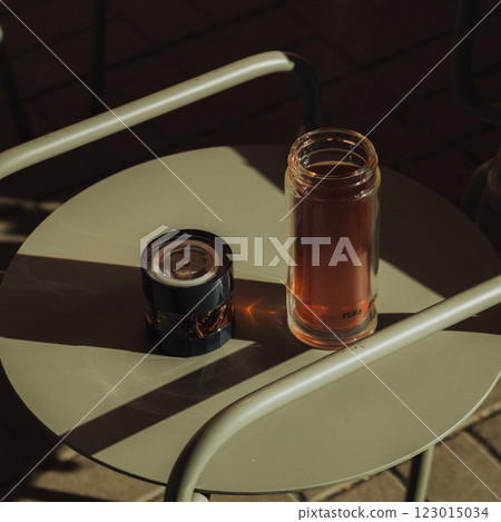 Cozy Afternoon Sipping a Warm Cup of Tea and Enjoying the Gentle Glow of a Candle on the Table 123015034