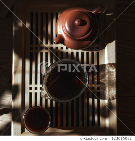 An Elegant Tea Set arranged beautifully on a Wooden Tray, enhanced by Natural Light An Elegant Tea Set arranged beautifully on a Wooden Tray, enhanced by Natural Light 123015092