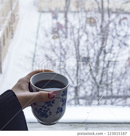 Im enjoying a Cozy Winter Moment, sitting by the window with a warm drink and its aroma Im enjoying a Cozy Winter Moment, sitting by the window with a warm drink and its aroma 123015187