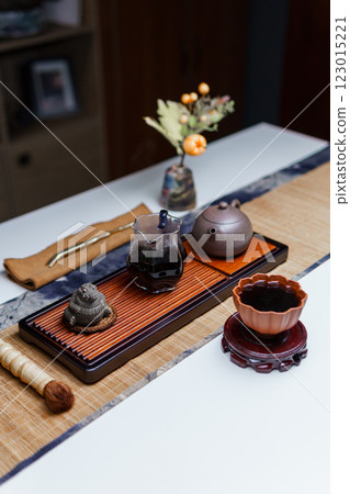 Elegant Traditional Tea Set Display, enhanced with a Floral Arrangement for aesthetics 123015221