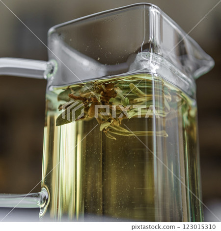 Enjoy a Herbal Tea Infusion served in an Elegant Glass Pitcher, enhancing your experience 123015310