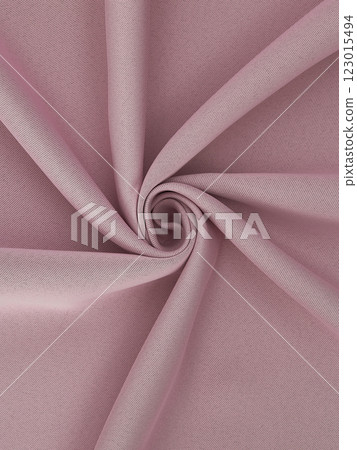 Close-up of twisted pink curtain fabric texture in smooth folds 123015494